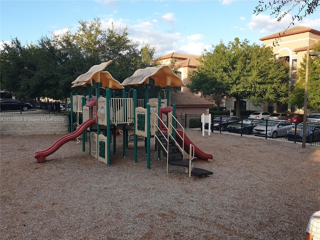 community jungle gym featuring fence