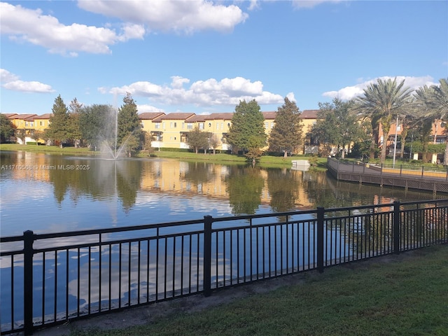 water view featuring a residential view and fence