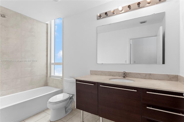 full bathroom with tile patterned flooring, vanity, toilet, and tiled shower / bath