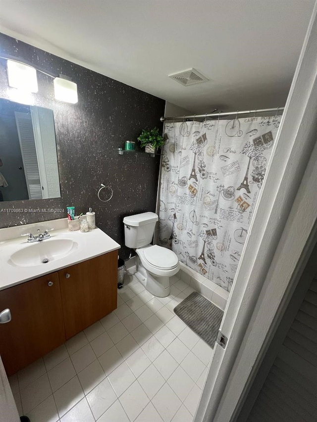 bathroom featuring tile patterned flooring, vanity, toilet, and a shower with shower curtain