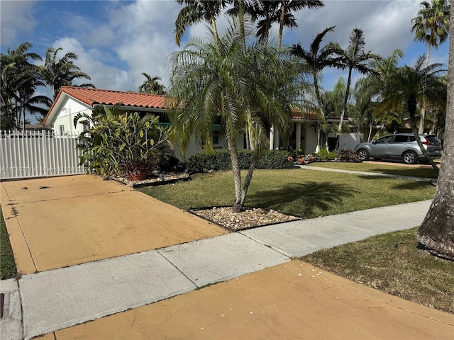 mediterranean / spanish-style house featuring a front yard