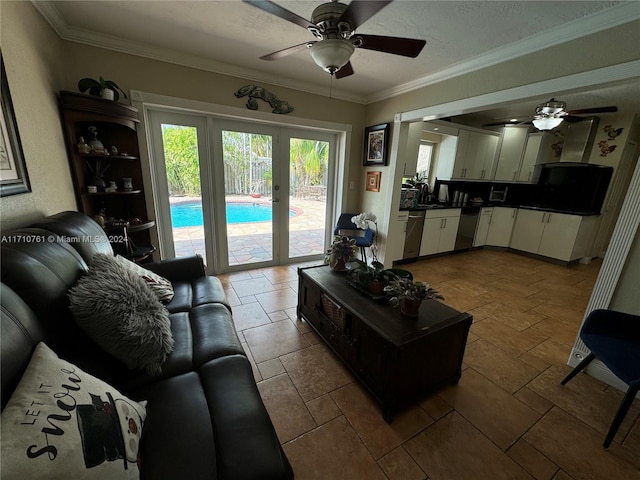 living room with a textured ceiling, ceiling fan, crown molding, and french doors