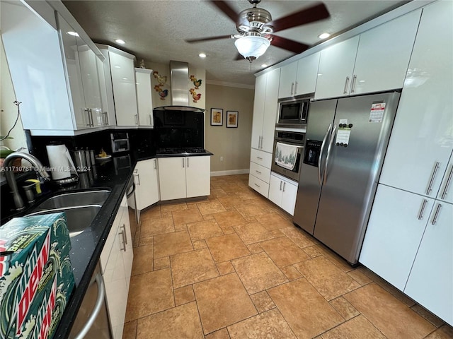 kitchen with white cabinets, sink, wall chimney exhaust hood, ornamental molding, and stainless steel appliances