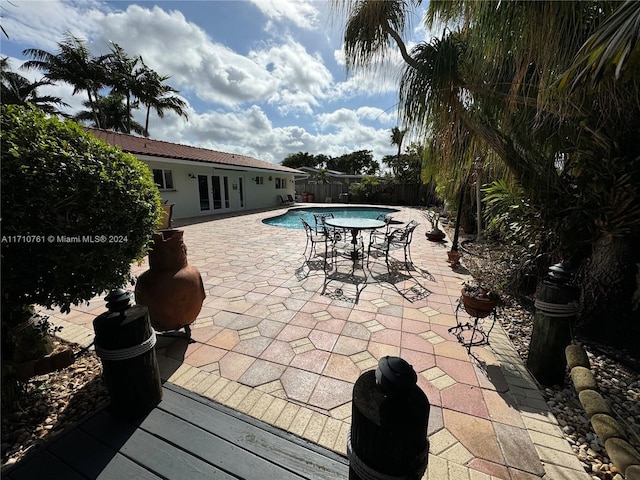 view of swimming pool featuring french doors and a patio