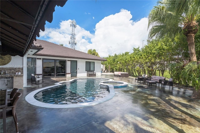 view of pool featuring an in ground hot tub, an outdoor living space, and a patio