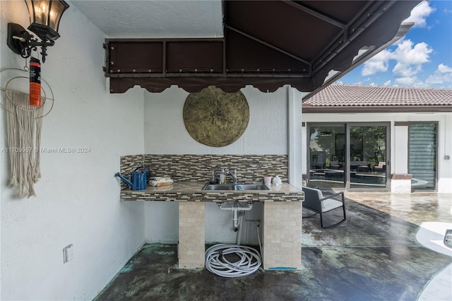 view of patio / terrace featuring sink and an outdoor kitchen