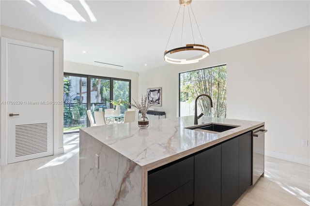 kitchen featuring decorative light fixtures, a spacious island, sink, and dishwasher