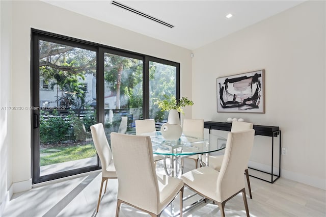 dining space with light hardwood / wood-style floors and a wealth of natural light