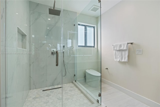 bathroom with toilet and an enclosed shower