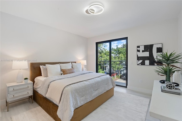 bedroom featuring access to outside and light wood-type flooring