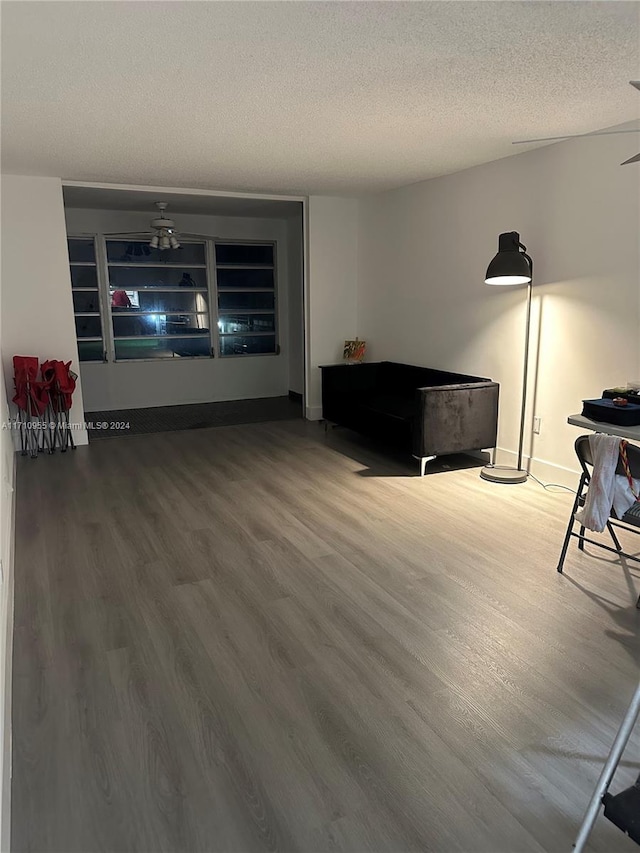 interior space featuring a textured ceiling, hardwood / wood-style flooring, and ceiling fan