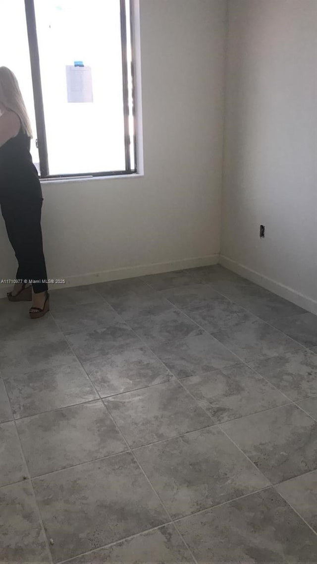 388 NE 208th Ter Unit 388, Miami, FL 33179 - tiled empty room with baseboards