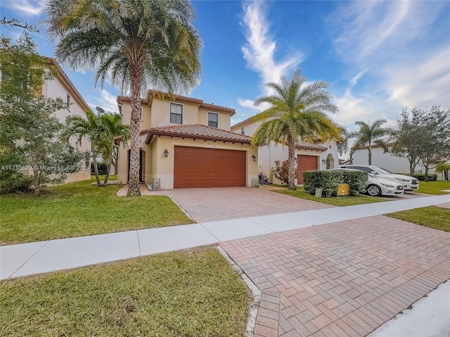 mediterranean / spanish-style home featuring a garage and a front lawn