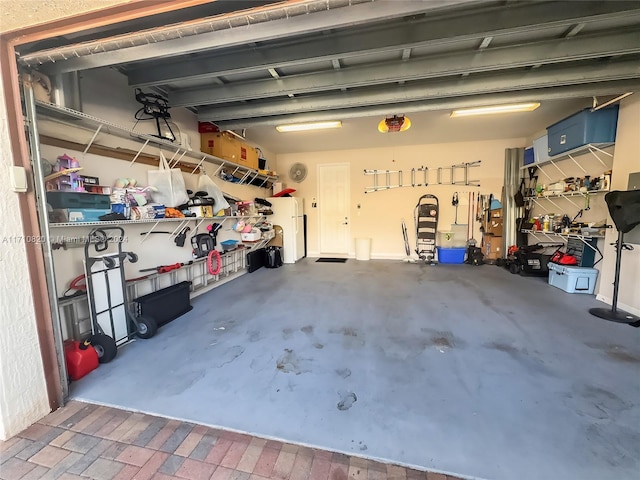 garage featuring white fridge