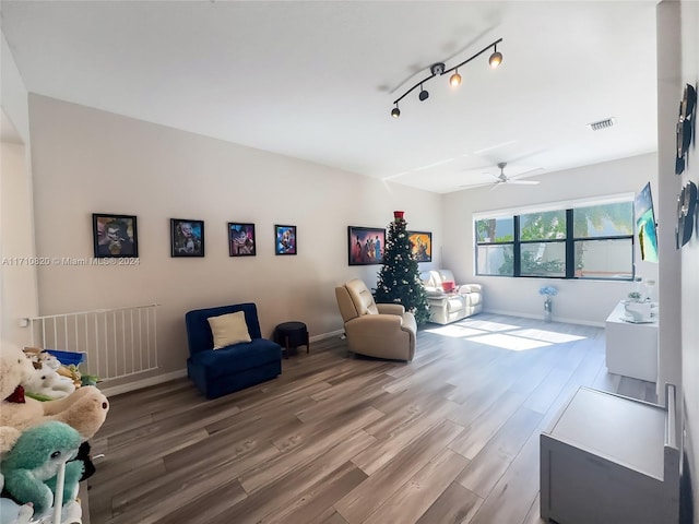 living area featuring ceiling fan and hardwood / wood-style floors