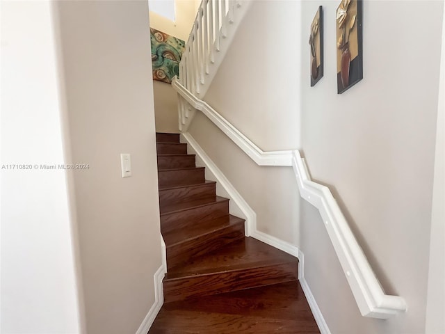 staircase with hardwood / wood-style flooring