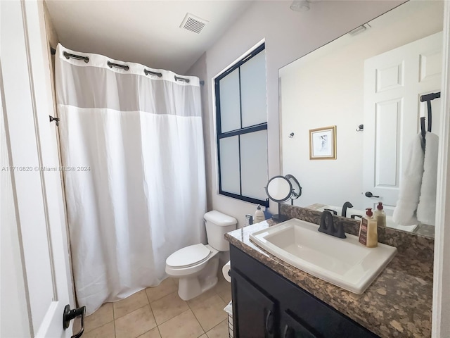 bathroom with tile patterned flooring, vanity, and toilet