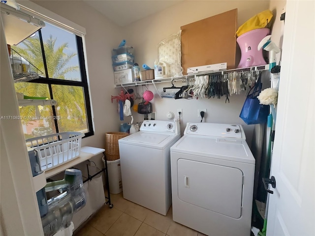 laundry area featuring light tile patterned floors and separate washer and dryer