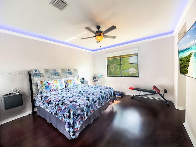 bedroom with hardwood / wood-style flooring, ceiling fan, and ornamental molding