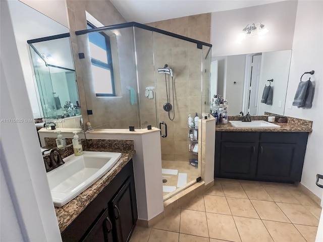 bathroom with tile patterned floors, vanity, and a shower with door