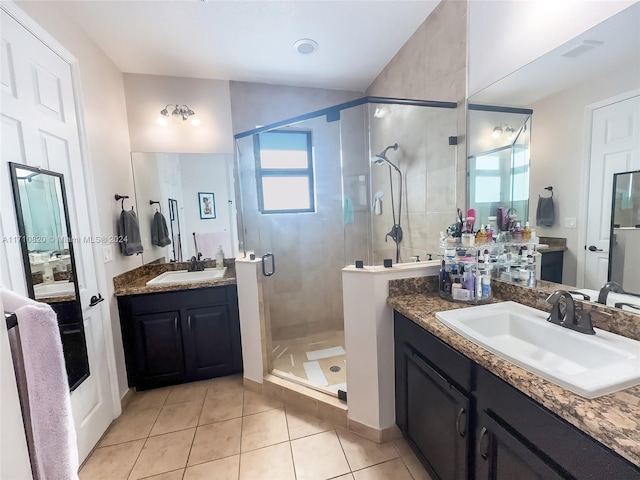 bathroom featuring tile patterned flooring, vanity, and a shower with shower door