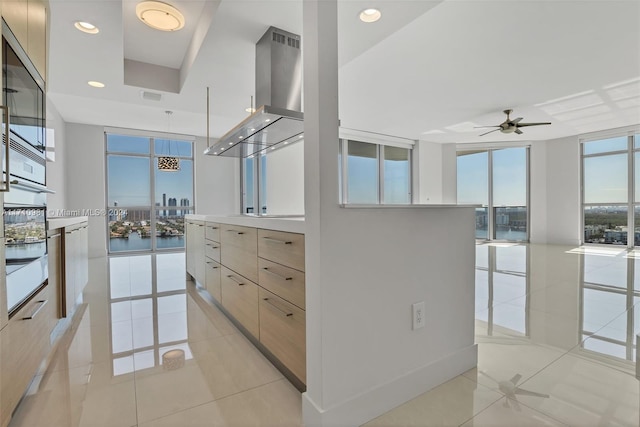 walk in closet with light tile patterned floors and ceiling fan