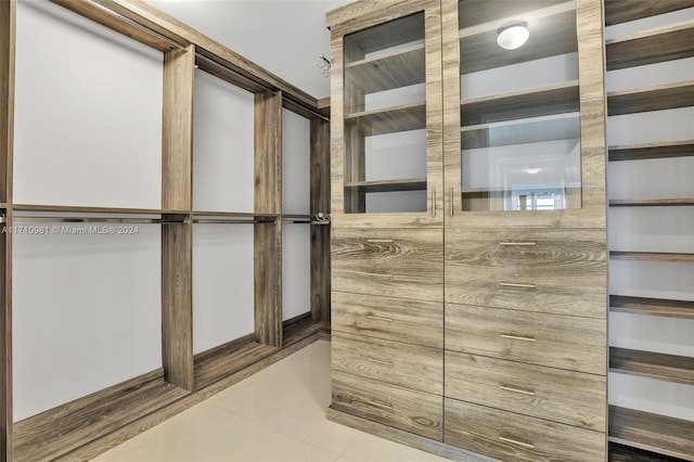 walk in closet featuring tile patterned flooring