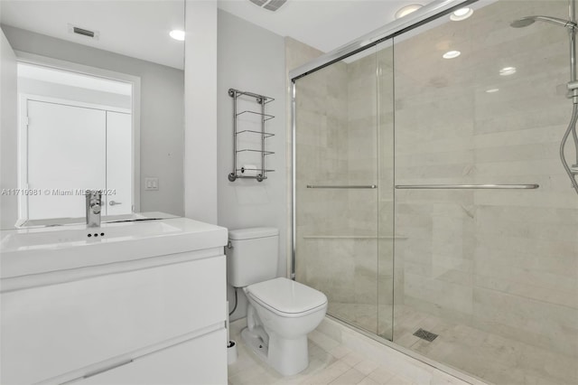 bathroom featuring walk in shower, vanity, and toilet