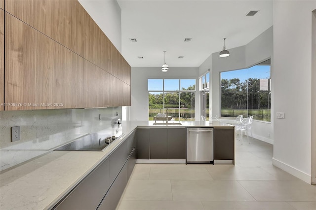 kitchen featuring decorative light fixtures, decorative backsplash, stainless steel dishwasher, light stone countertops, and black electric cooktop