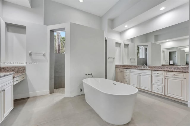 bathroom featuring plus walk in shower and vanity