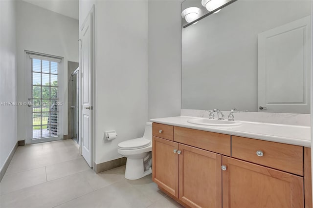 bathroom featuring vanity, tile patterned flooring, a shower with door, and toilet