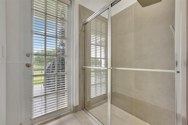 bathroom featuring a shower with shower door