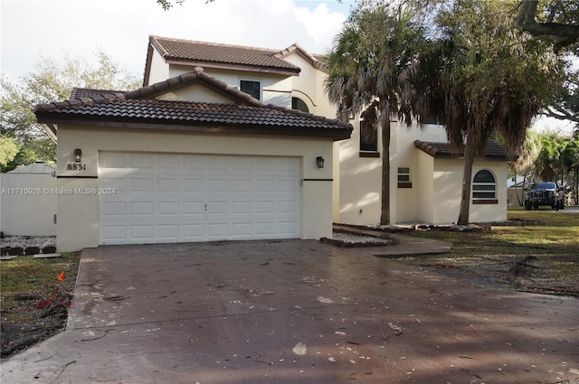 mediterranean / spanish-style home featuring a garage