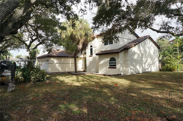 back of house with a lawn