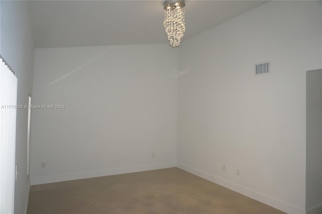 unfurnished room featuring an inviting chandelier