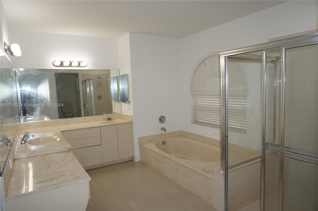 bathroom featuring shower with separate bathtub, vanity, and tile patterned floors