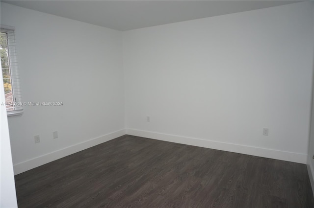 empty room featuring dark wood-type flooring