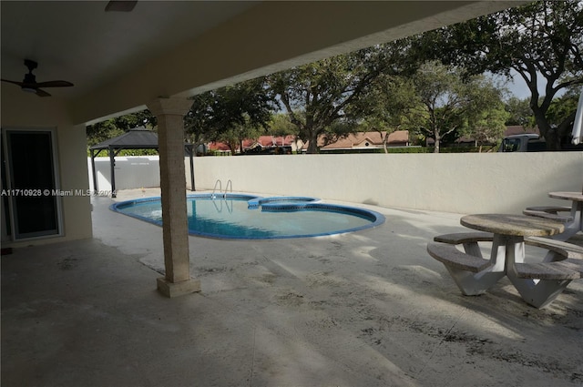 view of swimming pool featuring a gazebo, a jacuzzi, and a patio