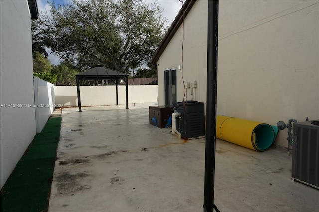 view of patio with a gazebo and central AC