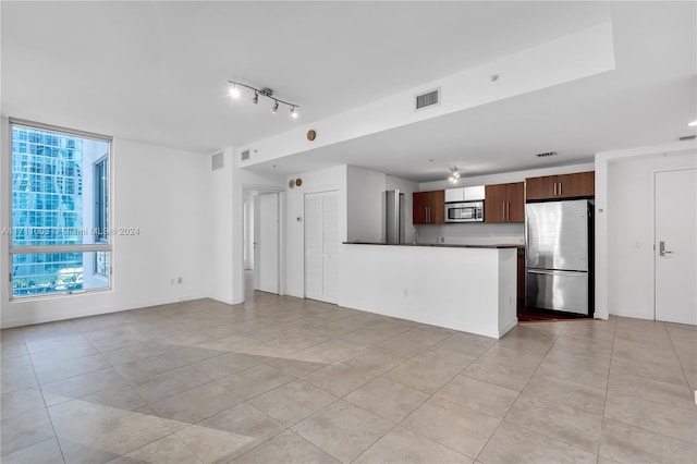 unfurnished living room featuring light tile patterned floors