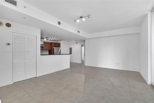 unfurnished living room featuring light tile patterned flooring