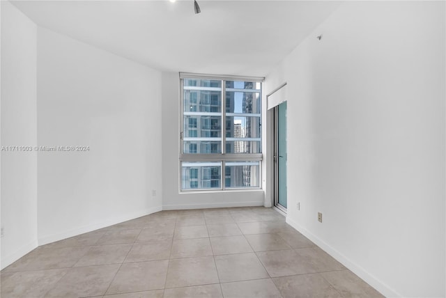 empty room with light tile patterned floors