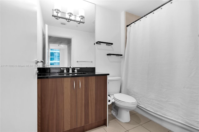 bathroom with tile patterned floors, vanity, and toilet