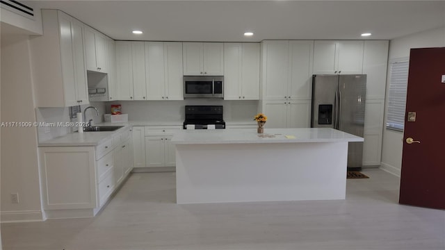 13455 SW 9th Ct Unit 113J, Pembroke Pines, FL 33027 - kitchen featuring stainless steel appliances, white cabinetry, recessed lighting, light countertops, and a center island