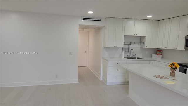13455 SW 9th Ct Unit 113J, Pembroke Pines, FL 33027 - kitchen with white cabinets, light countertops, recessed lighting, and backsplash