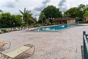 13455 SW 9th Ct Unit 113J, Pembroke Pines, FL 33027 - community pool featuring a patio area
