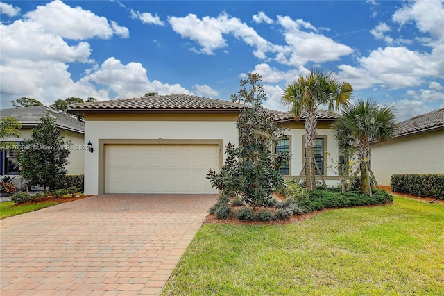 mediterranean / spanish house featuring a front yard and a garage