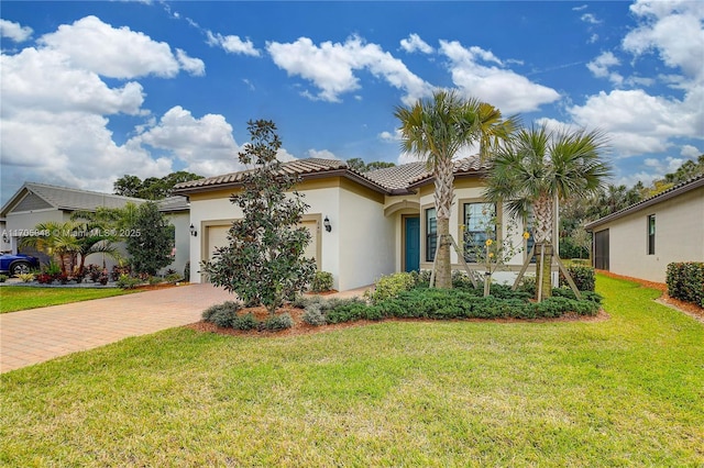 mediterranean / spanish-style house with a garage and a front yard