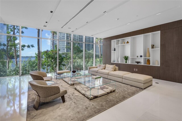 living room featuring a wall of windows and wooden walls