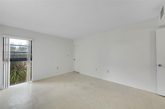 empty room with a textured ceiling